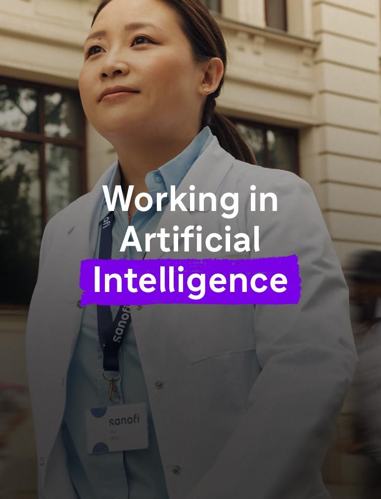 A woman in a white Sanofi lab coat and company badge outside of a building, moving forward while confidently and positively looking ahead. Several people are running alongside her in the background, they are blurred in motion.. Overlay text reads: "Working in Artificial Intelligence."​