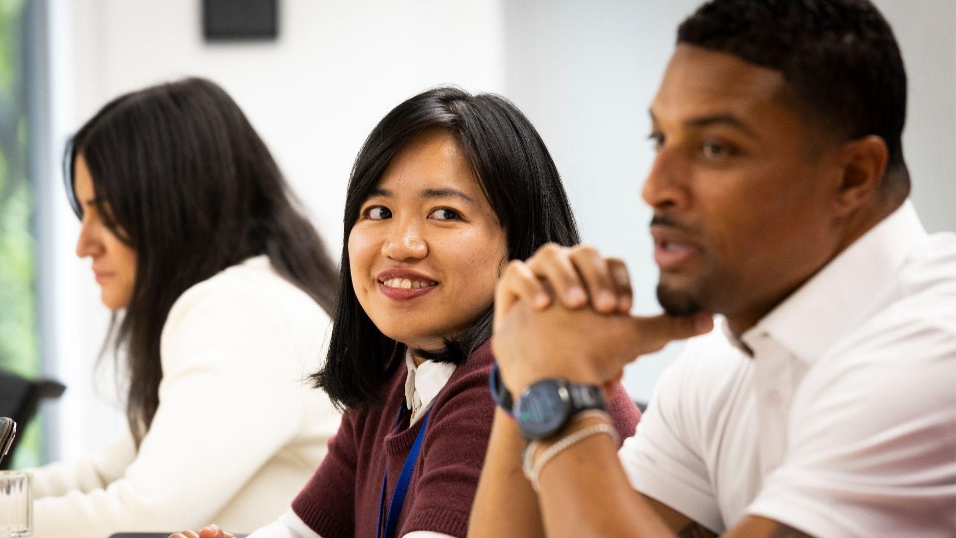 3 Sanofians sitting in a row during a workshop