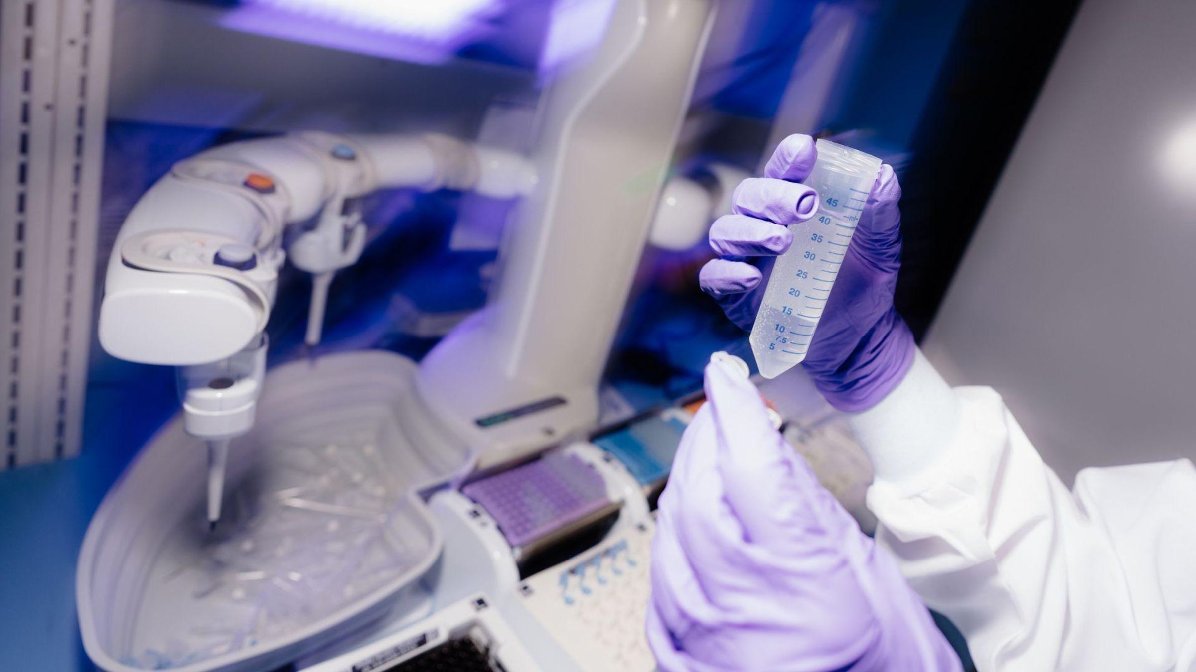 Hand holding a liquid sample, preparing for mass spectrometry analysis