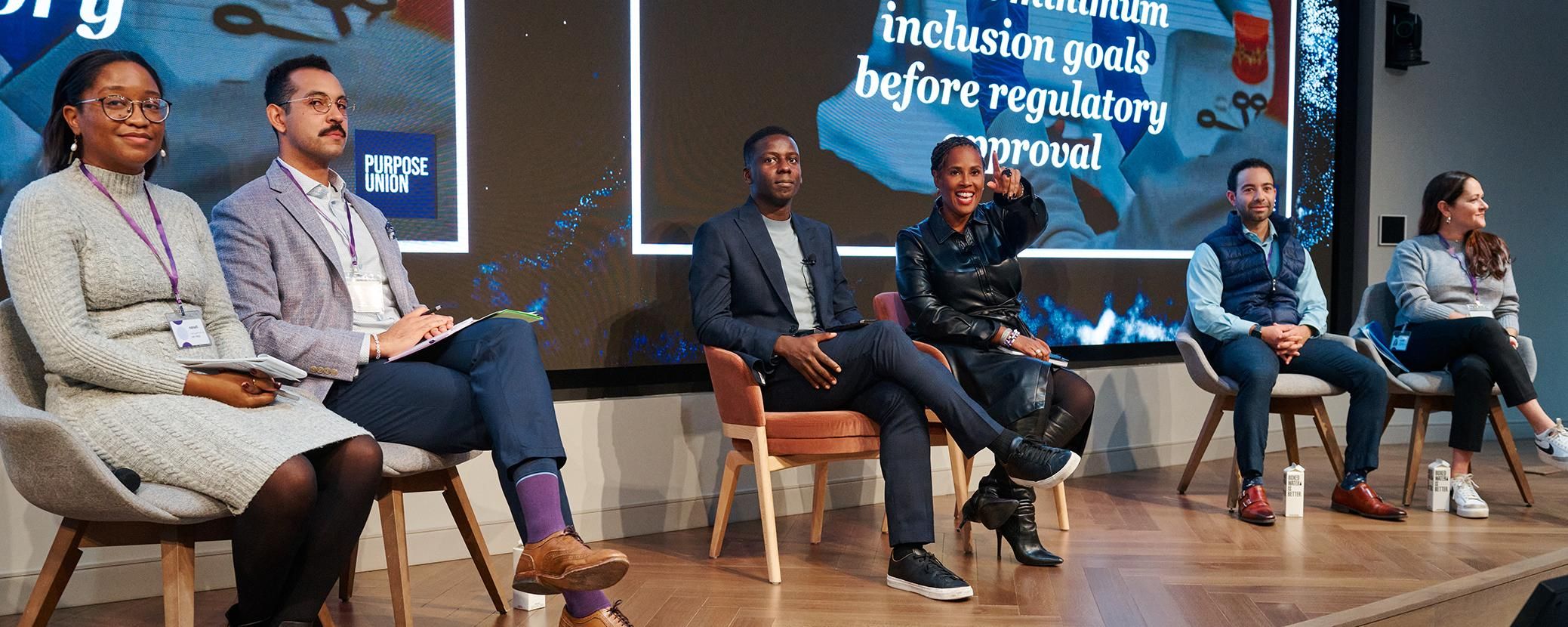The Art of Dialogue panel participants led by Lewis Iwu and Tanisha Sullivan at the 2025 TIE Summit sitting on stage as they listen to questions from the crowd.