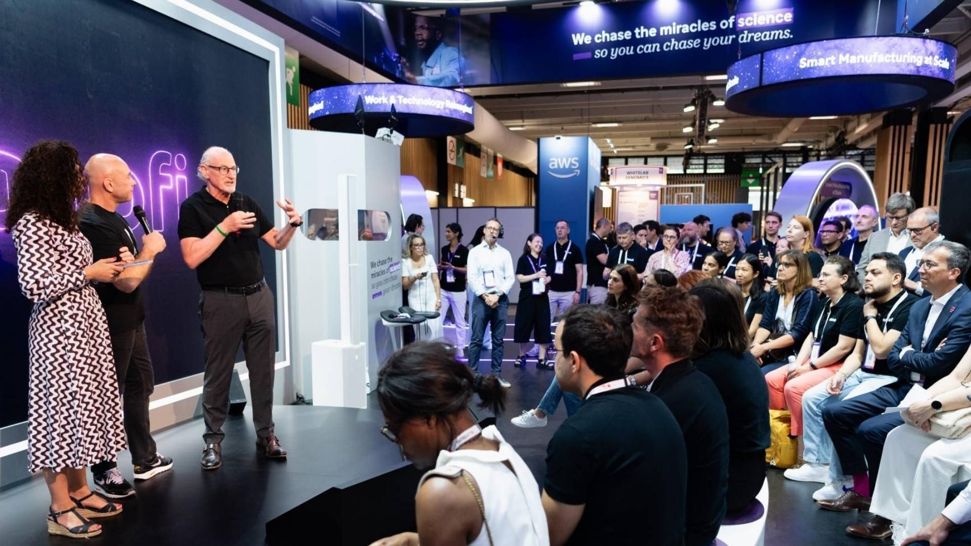 Sanofi VivaTech stage presentation with CDO Emmanuel Frenehand and Head of M&S Brendan O'Callaghan addressing seated audience.