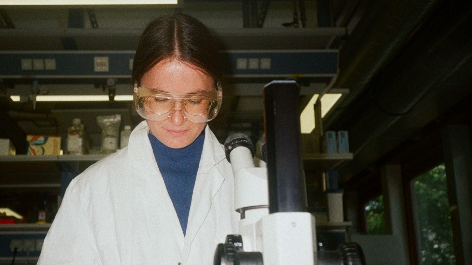 Five smiling people standing together outdoors