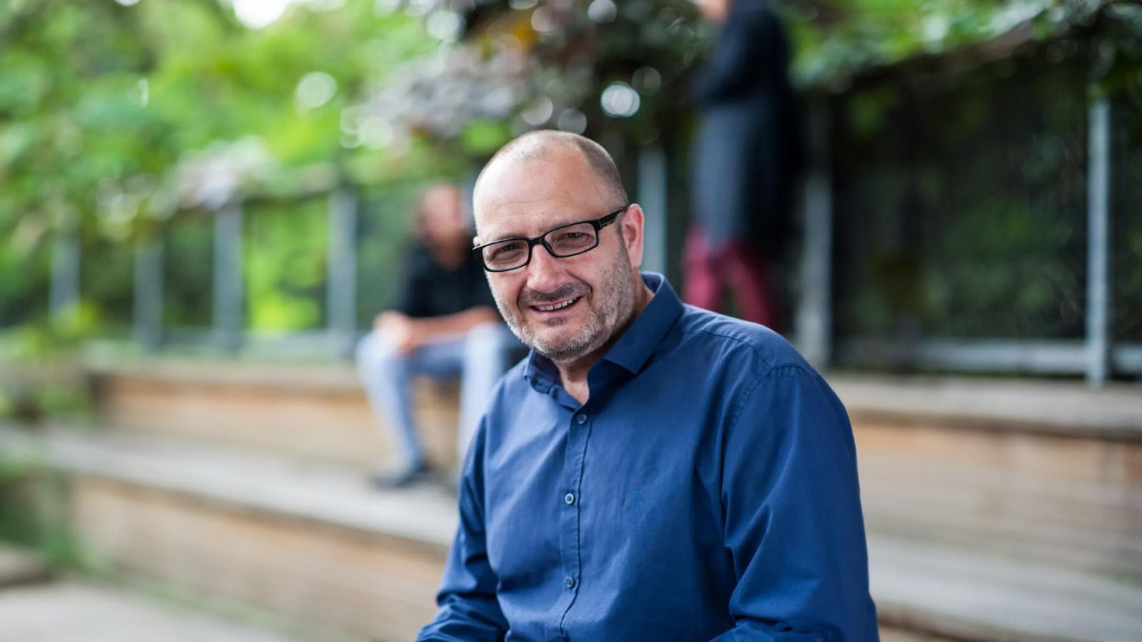 Portrait of Dave, a British man with multiple sclerosis, smiling and looking at the camera