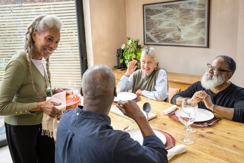 Elizabeth, Stan, Di and Ray conversing in dining area