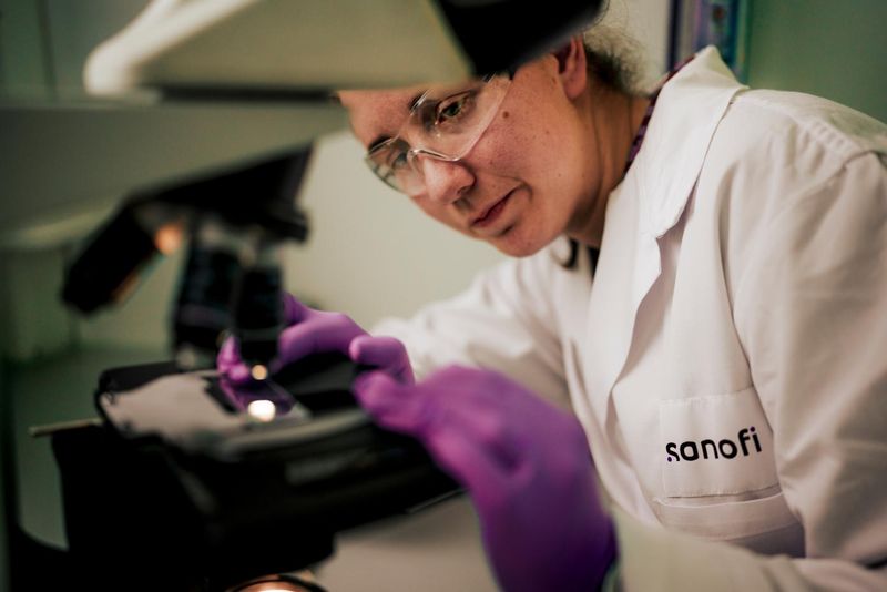 An-Sophie Claerbout, Associate Scientist at Sanofi's Ghent, Belgium facility, working in a laboratory environment. She is focused on scientific research as part of Sanofi's R&D team.